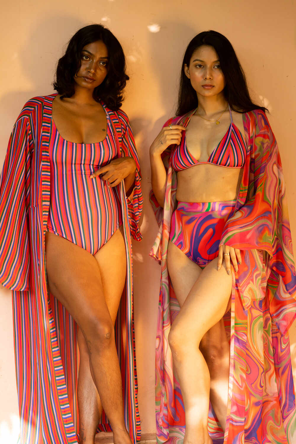 two girls wearing izsi swimwear India, beach cover ups of kaftan. She is wearing a monokini or one piece swimsuit. 